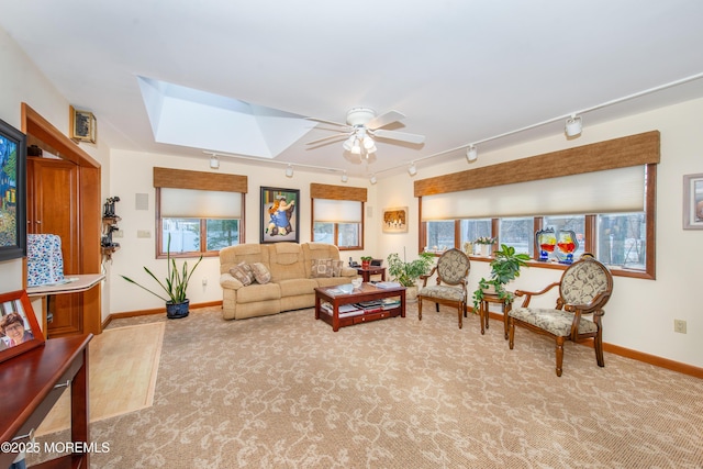 carpeted living room with ceiling fan and track lighting