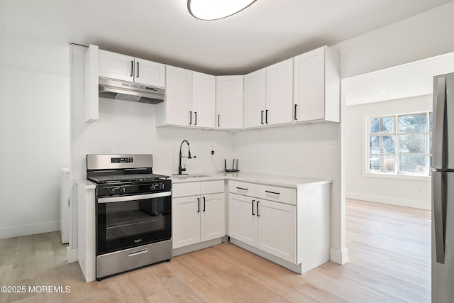 kitchen featuring white cabinetry, appliances with stainless steel finishes, and light hardwood / wood-style flooring