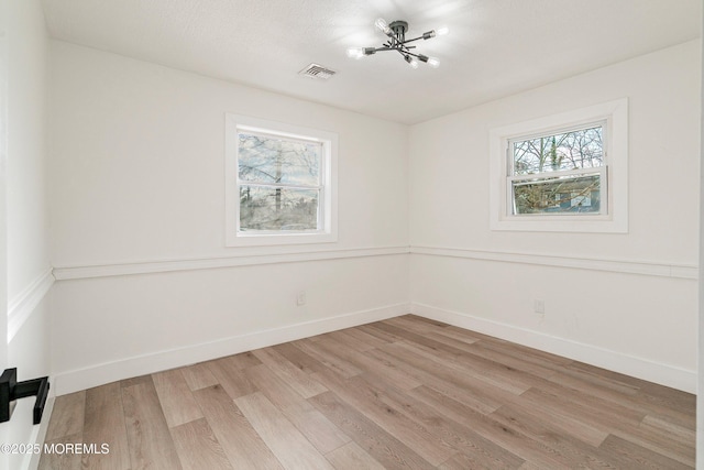 spare room with light wood-type flooring