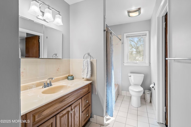 full bathroom featuring shower / bath combination with curtain, toilet, vanity, baseboards, and tile patterned floors