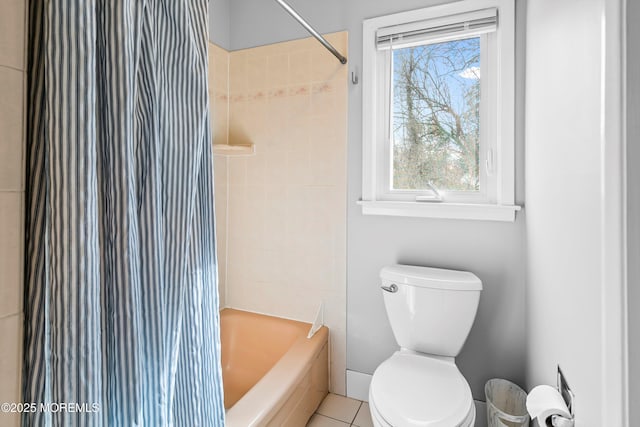 bathroom with shower / bath combination with curtain and toilet