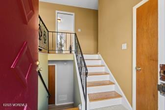 staircase featuring baseboards