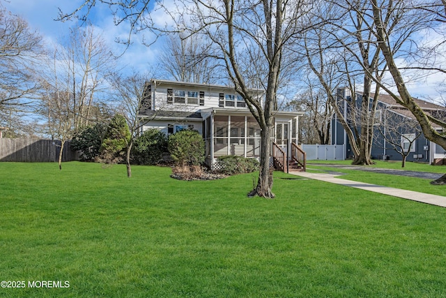 front facade with a front lawn and a sunroom