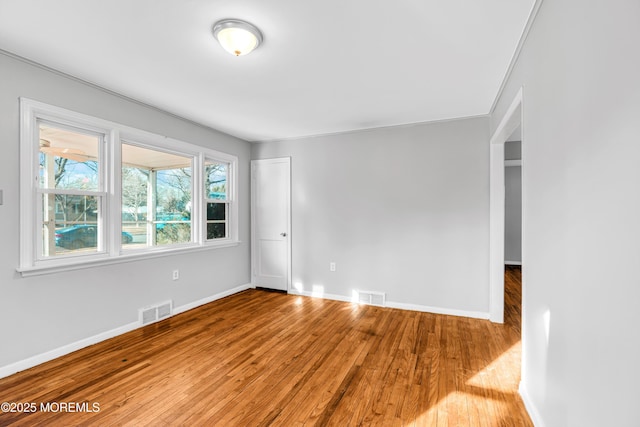 unfurnished room with hardwood / wood-style floors