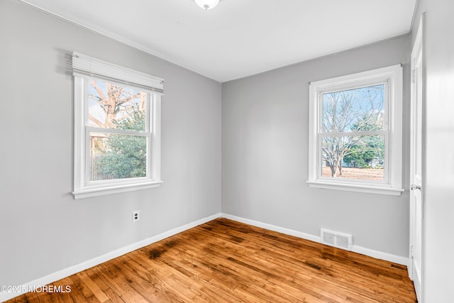 unfurnished room with light hardwood / wood-style floors