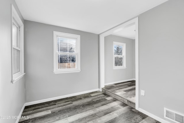 spare room featuring dark hardwood / wood-style floors