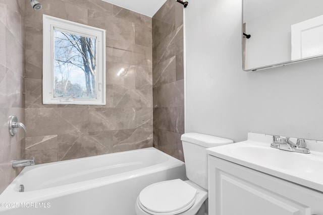 full bathroom with tiled shower / bath, vanity, and toilet