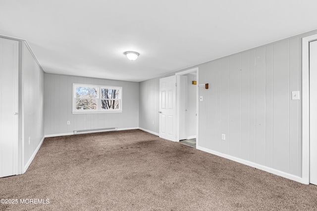 carpeted spare room with a baseboard radiator