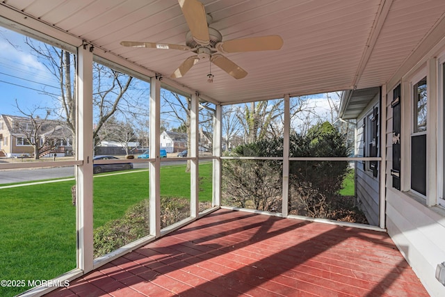 unfurnished sunroom featuring ceiling fan