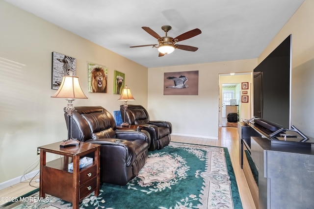 living room featuring hardwood / wood-style flooring and ceiling fan