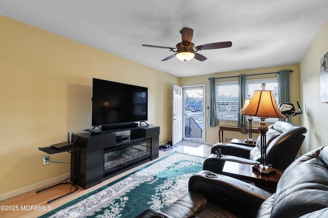 living room with hardwood / wood-style flooring and ceiling fan