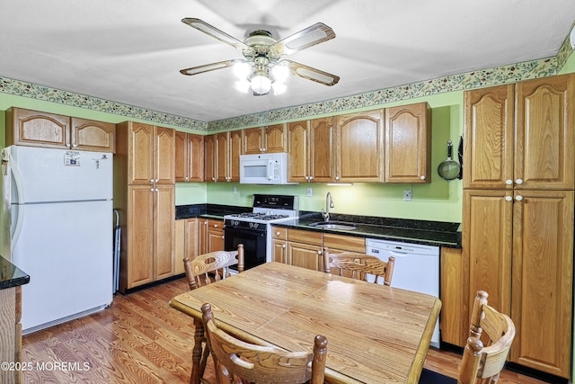 kitchen with dark hardwood / wood-style flooring, sink, ceiling fan, and white appliances