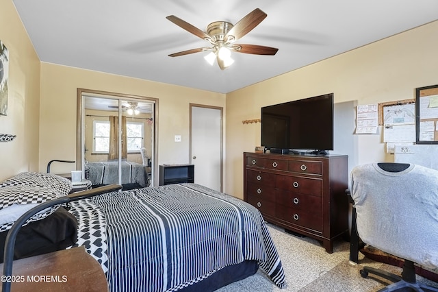 bedroom featuring ceiling fan and light carpet