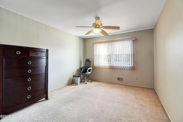 unfurnished bedroom featuring ceiling fan and light carpet