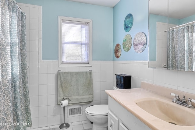 bathroom featuring tile walls, vanity, curtained shower, and toilet