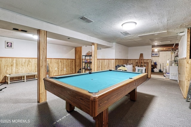 recreation room with gas water heater, wooden walls, carpet, pool table, and a textured ceiling