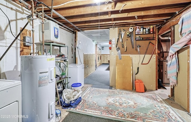 basement with water heater and washer / dryer