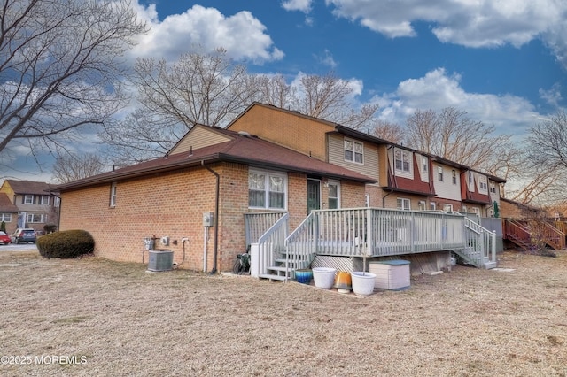 back of property featuring cooling unit and a deck