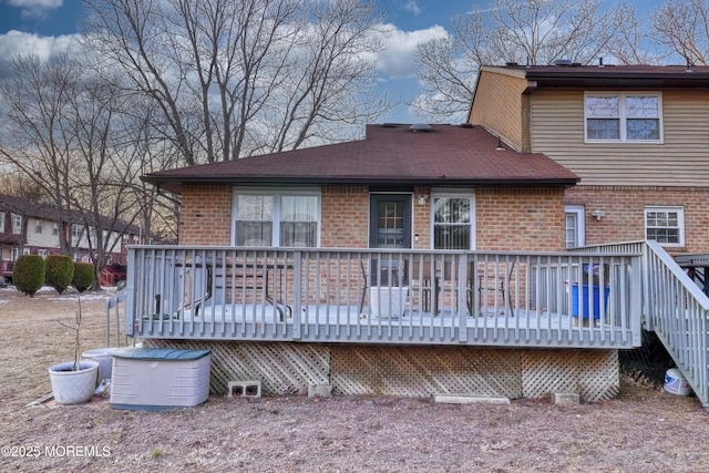 back of house with a deck