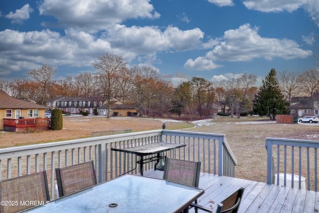 wooden terrace featuring a lawn