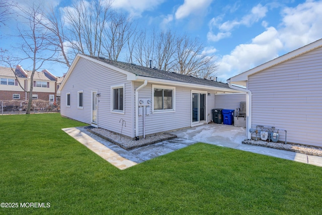 back of house with a patio and a yard