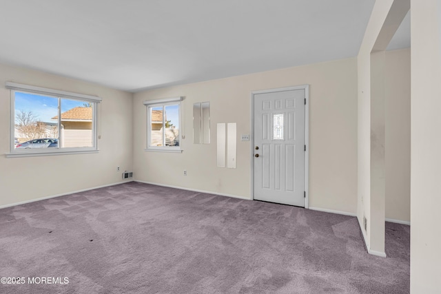 view of carpeted foyer entrance