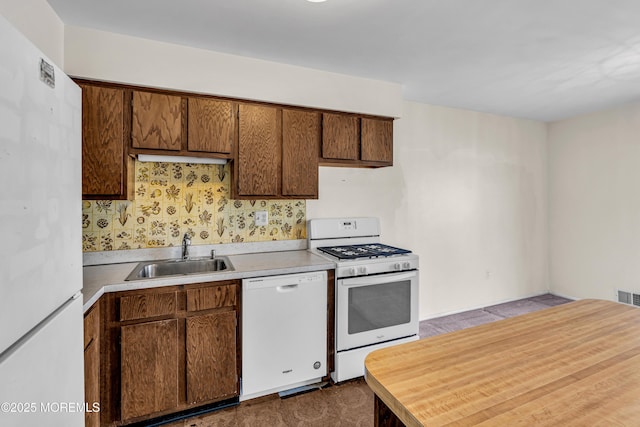 kitchen featuring sink and white appliances