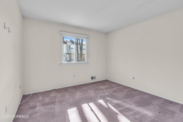 unfurnished room with light colored carpet