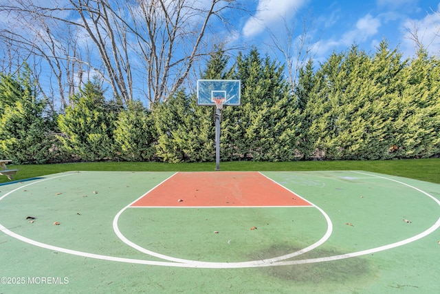 view of sport court with a lawn