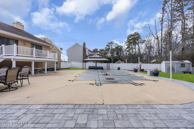 view of pool featuring a storage shed, a gazebo, and a patio area