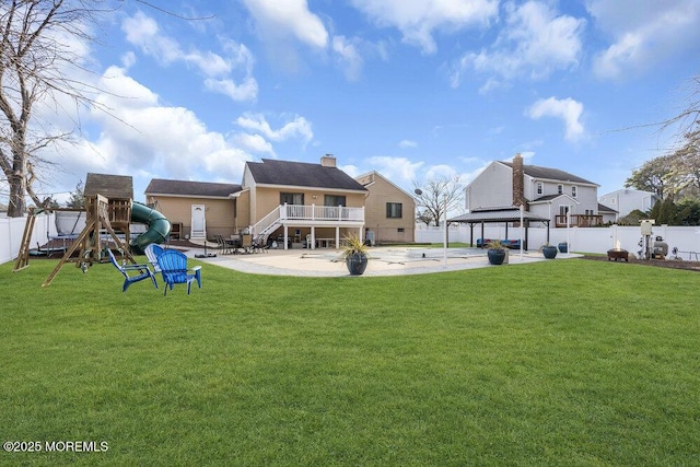 rear view of house with a gazebo, a playground, a patio area, and a lawn