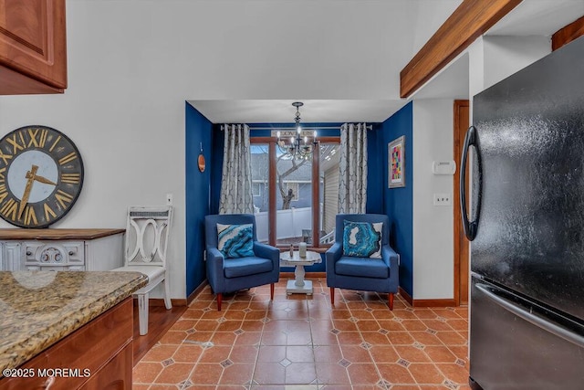 living area featuring tile patterned flooring and a notable chandelier