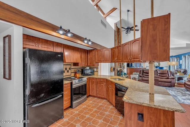 kitchen with sink, kitchen peninsula, light stone counters, and black appliances