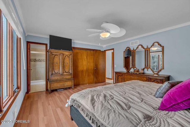 bedroom with crown molding, ceiling fan, a closet, and light wood-type flooring