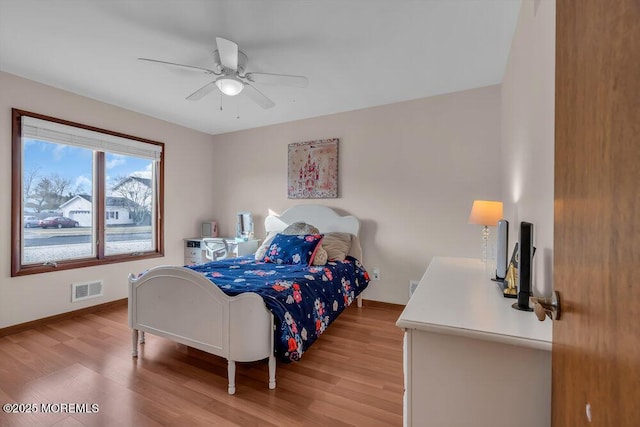 bedroom with hardwood / wood-style floors and ceiling fan