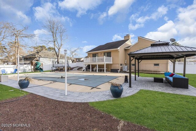 exterior space with a gazebo, a covered pool, cooling unit, a playground, and a patio