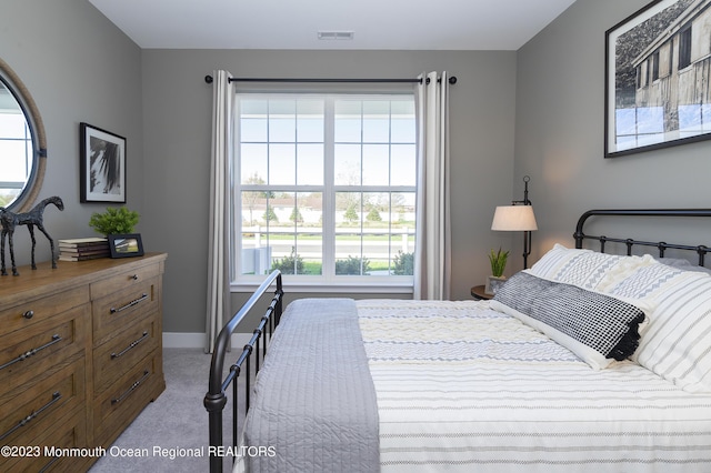 bedroom featuring light colored carpet