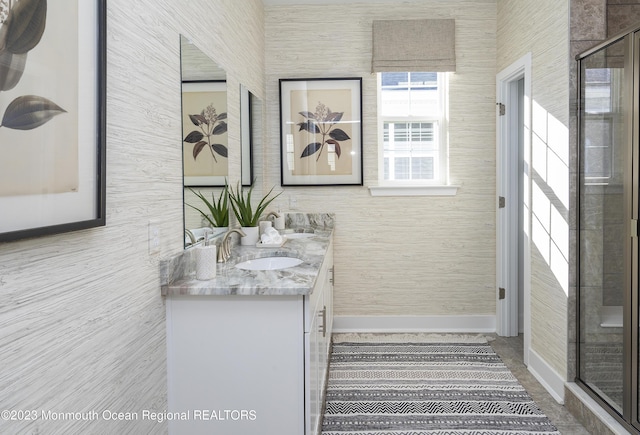 bathroom featuring walk in shower and vanity