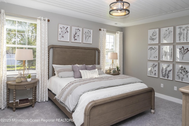 bedroom featuring wood ceiling and carpet floors