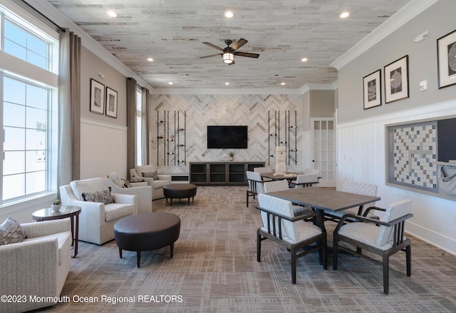 carpeted dining room with ornamental molding and ceiling fan