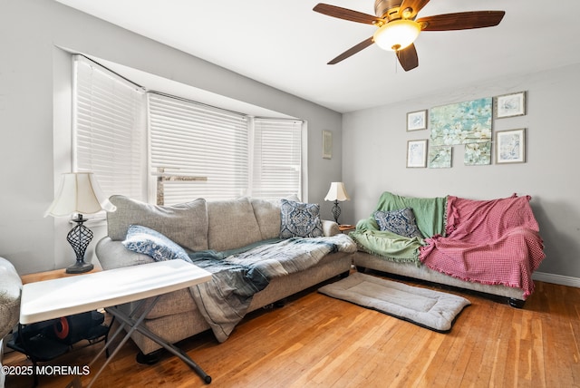 living room featuring hardwood / wood-style flooring and ceiling fan