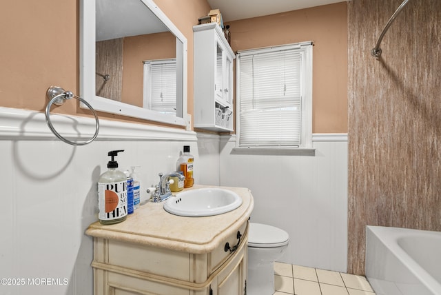 full bathroom featuring vanity, tile patterned floors, toilet, and washtub / shower combination