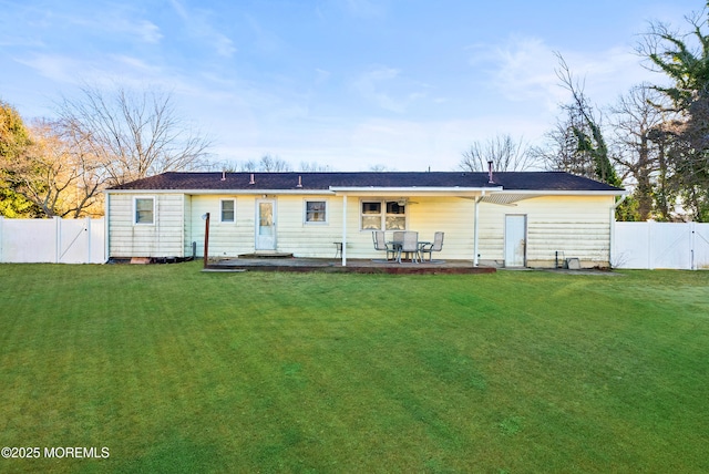 rear view of house featuring a yard and a patio area