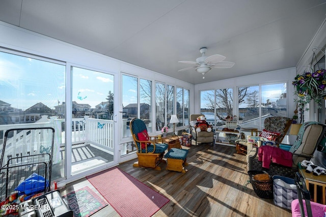 sunroom / solarium featuring ceiling fan