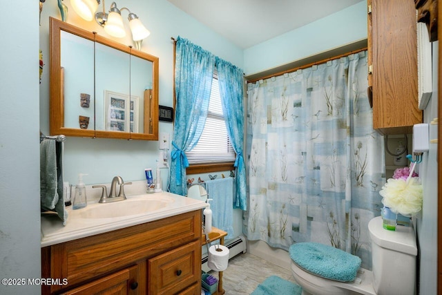 bathroom with a baseboard radiator, vanity, and toilet