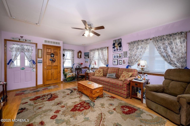 living room with ceiling fan and light wood-type flooring