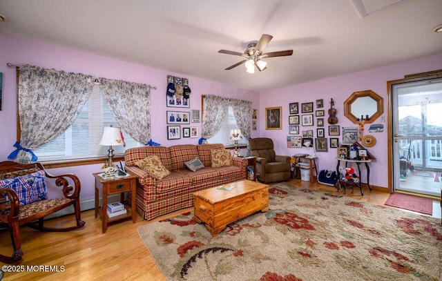 living room with light hardwood / wood-style floors and ceiling fan