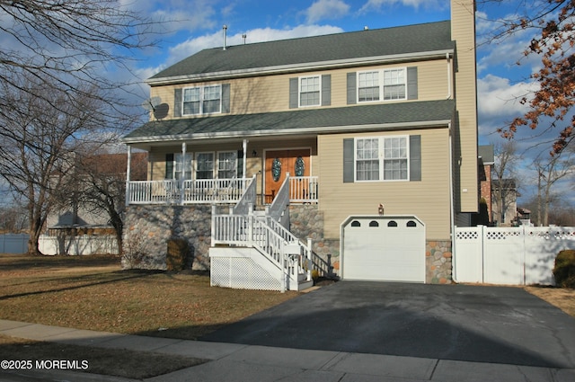 view of front of property featuring a porch and a garage