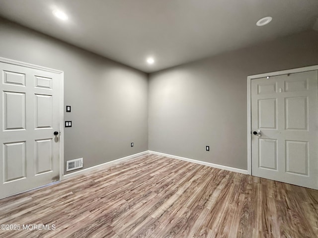 unfurnished room with light wood-type flooring