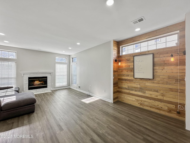 living room featuring dark hardwood / wood-style floors and wood walls